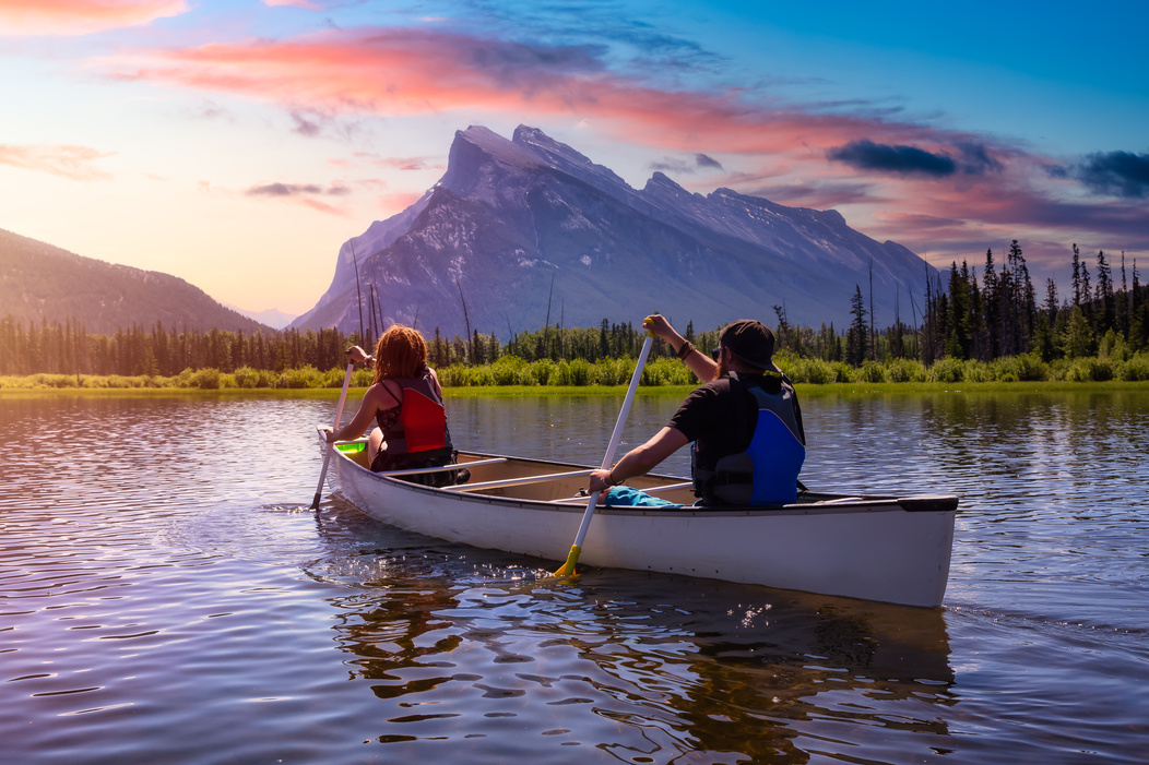 Couple Adventurous Friends Are Canoeing in a Lake 
